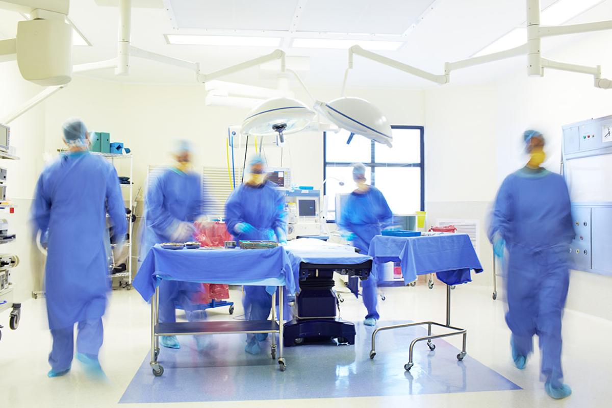 Surgeons performing pre-operation surgical preparations in an operating room