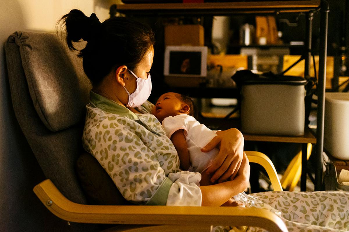 Mother cradling baby