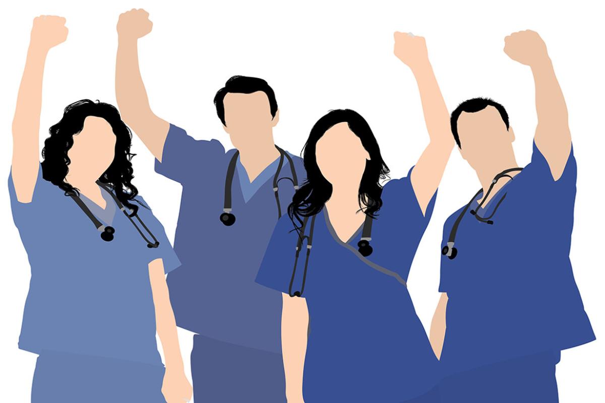Medical personnel with arms raised in the air