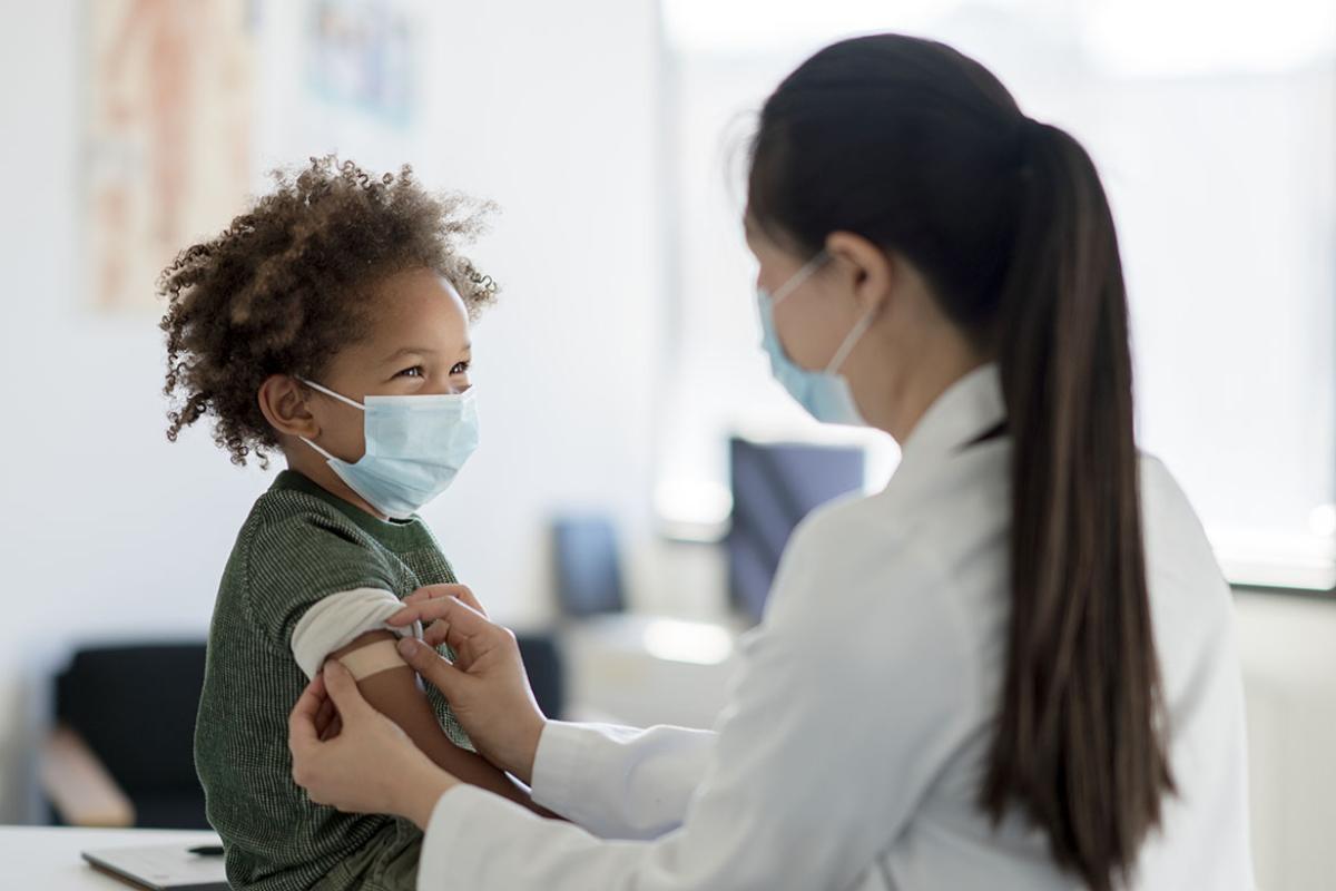 Child under 5 receiving vaccine shot