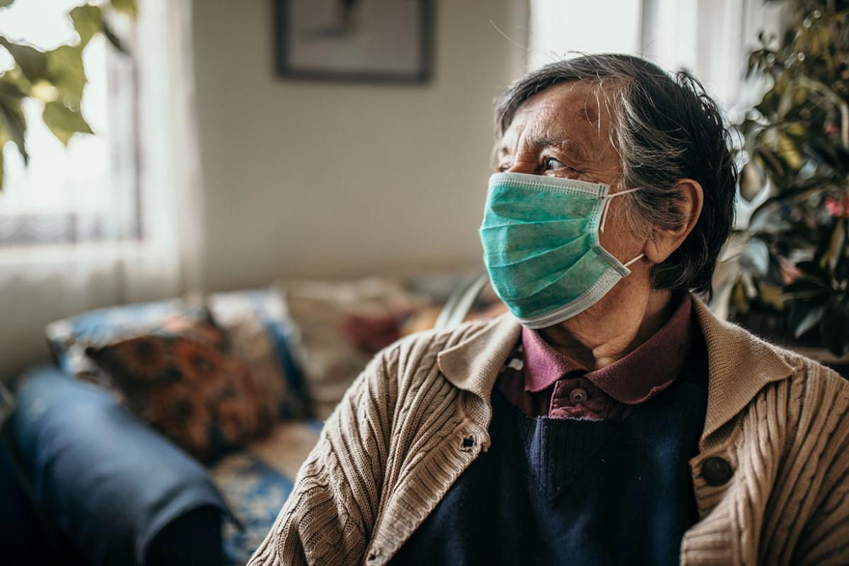 Masked person looking off to the distance