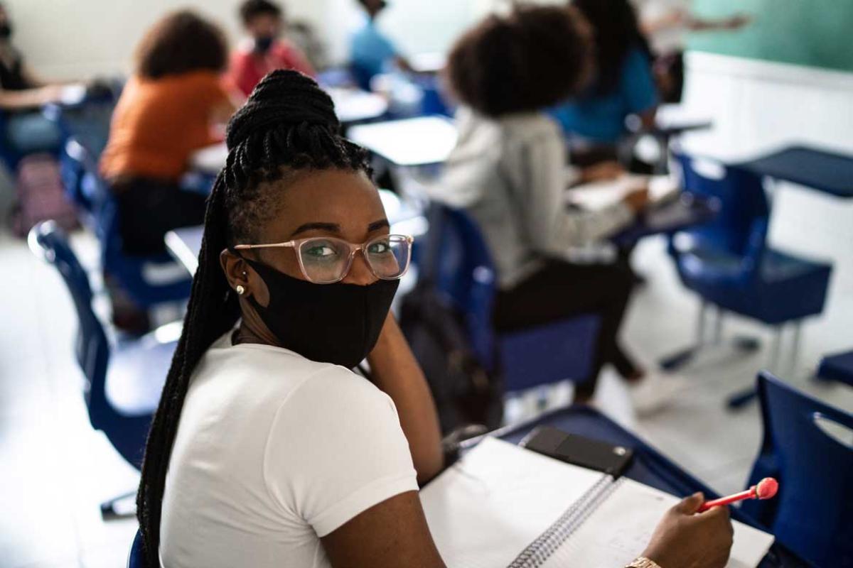 Masked person in a classroom