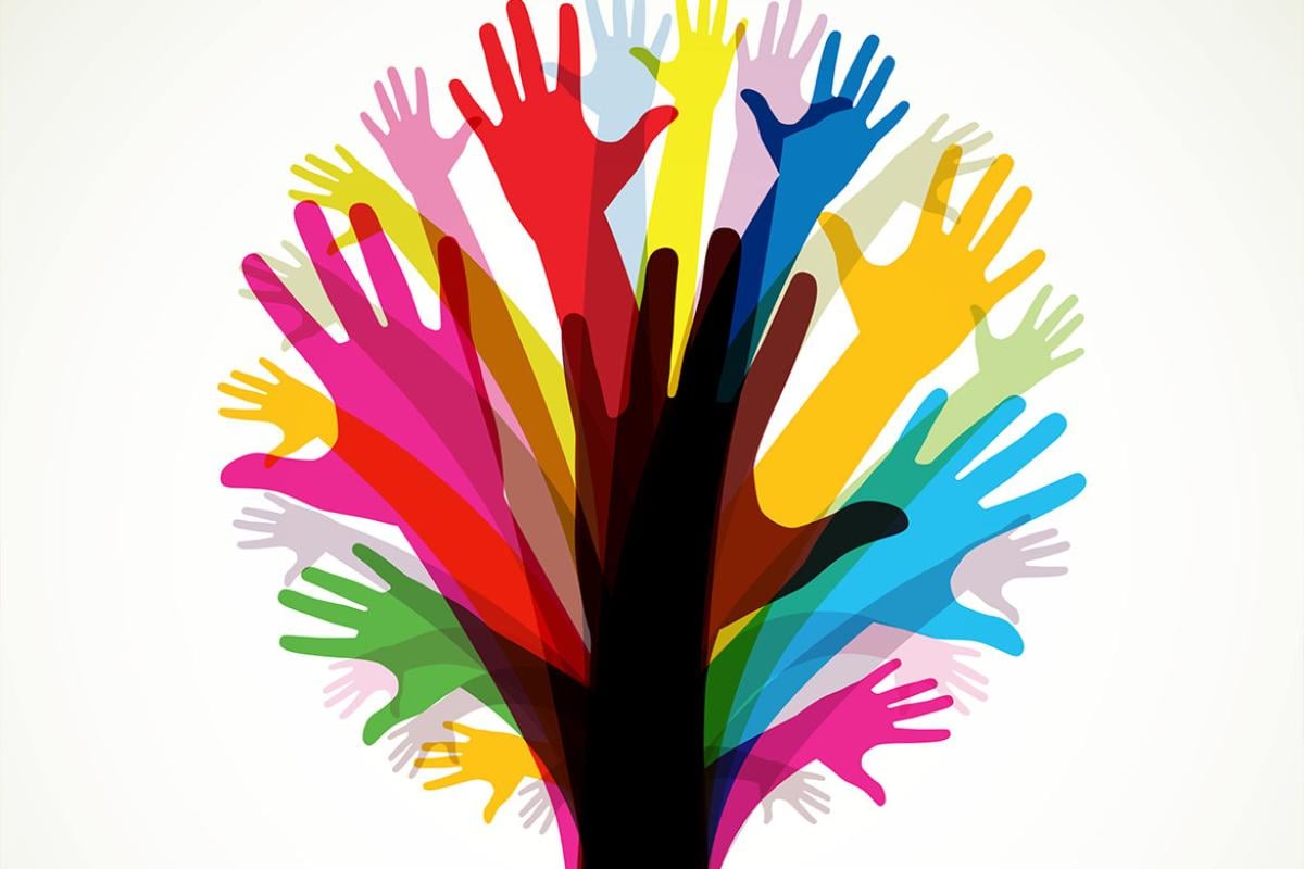 Group of multi-colored hands together making the shape of a tree