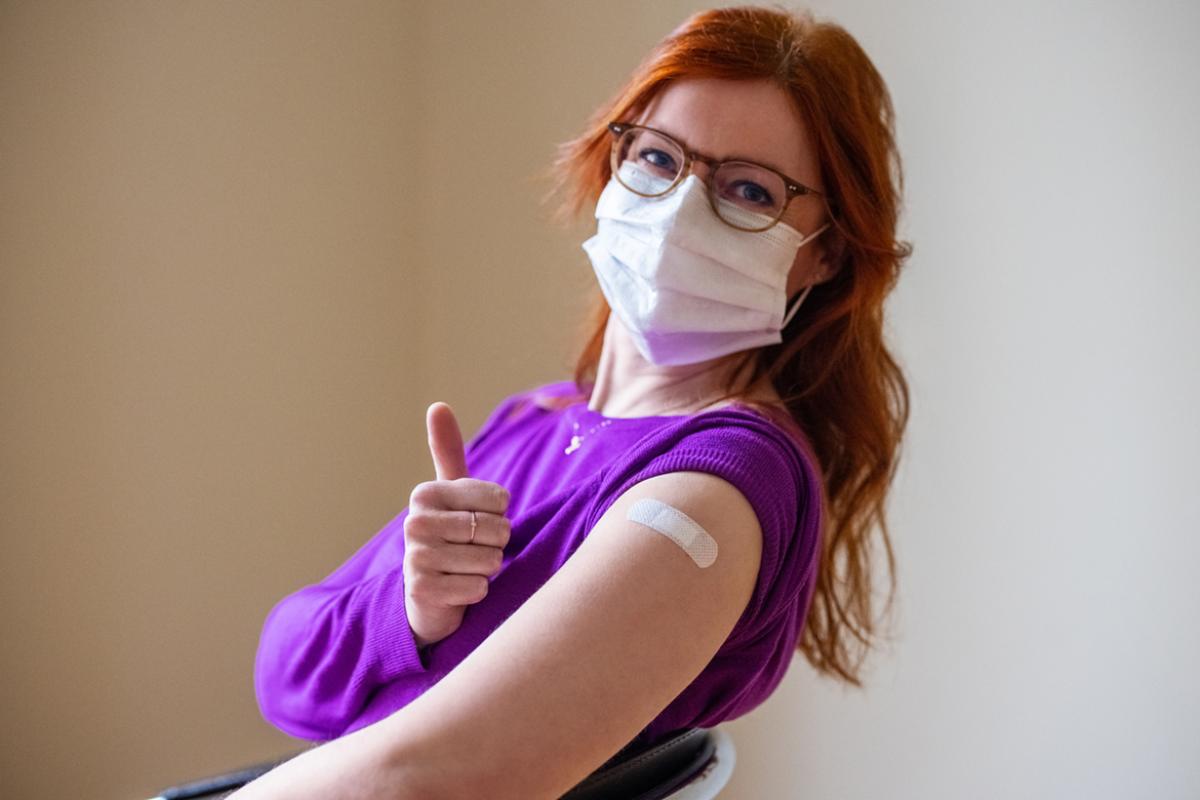 Smiling person giving a thumbs up