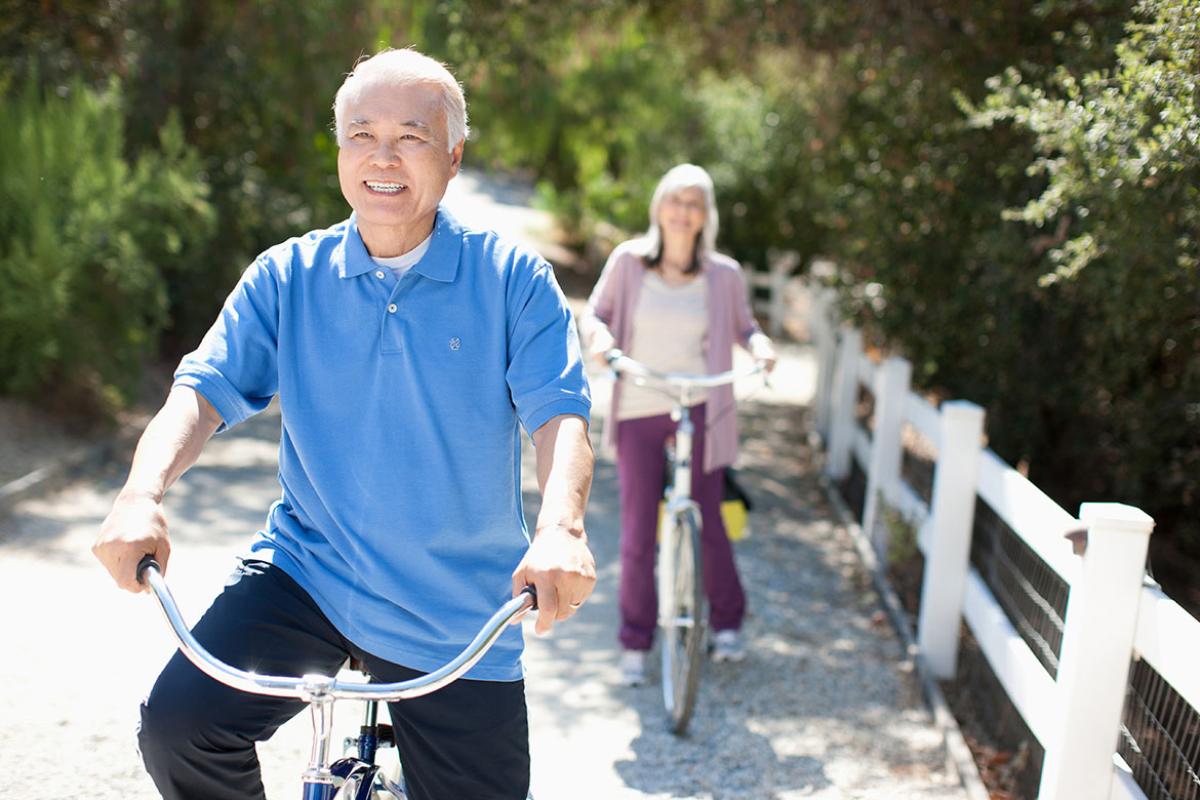 Smiling couple riding bicycles