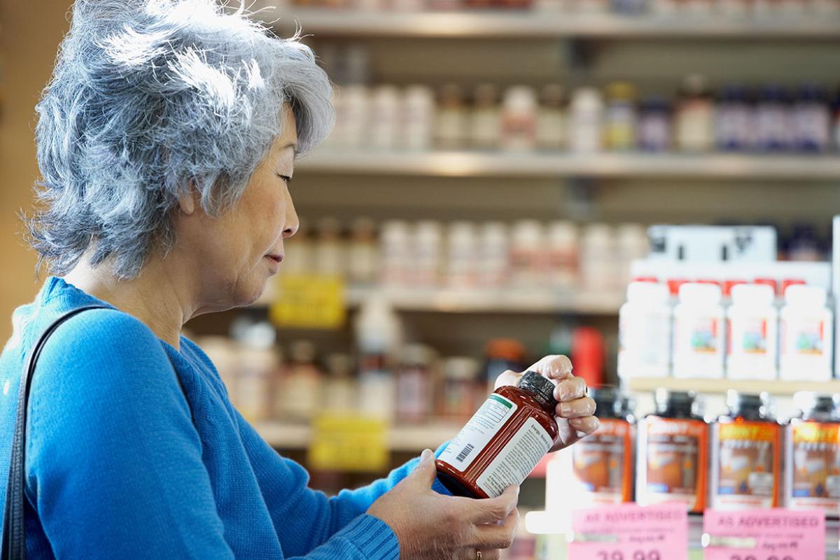 Person reading a supplement label