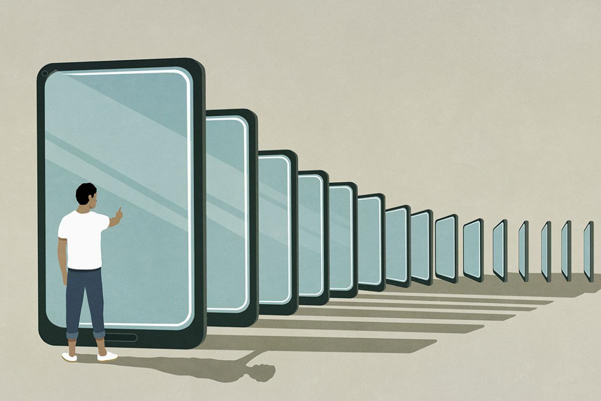 Standing figure in front of electronic devices