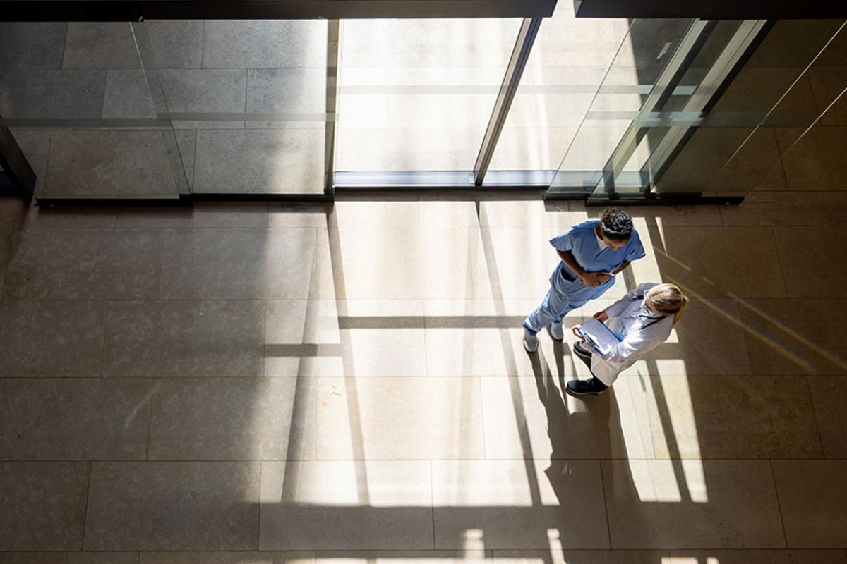Overhead view of two health care workers in conversation