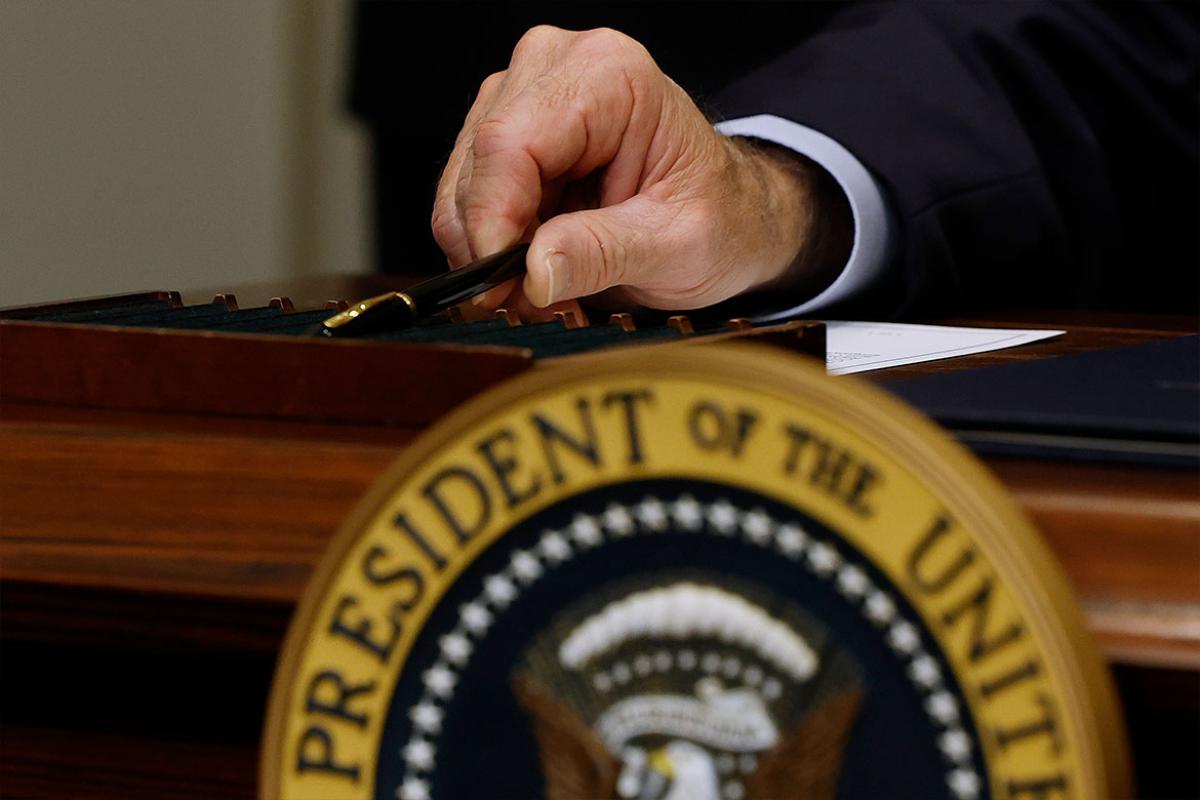 U.S. President Joe Biden holds a pen used to sign legislation