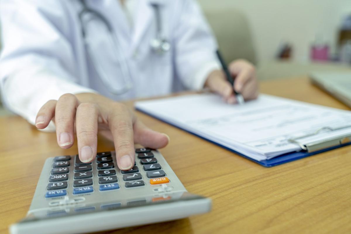 Physician using a calculator