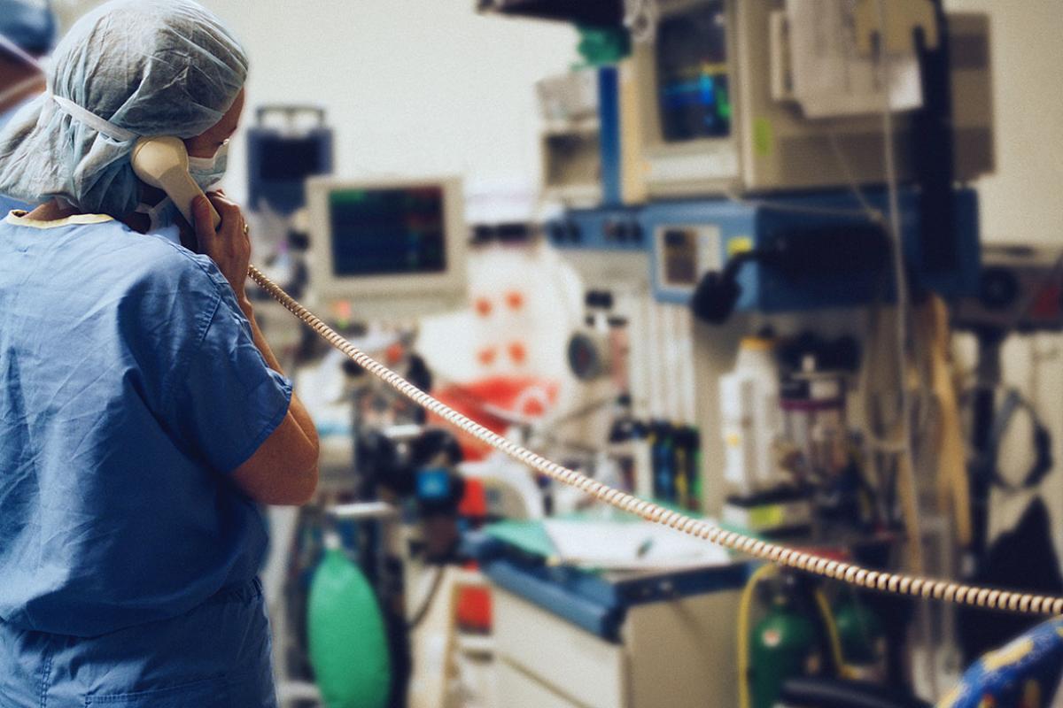 Health care worker talking on phone in operating room