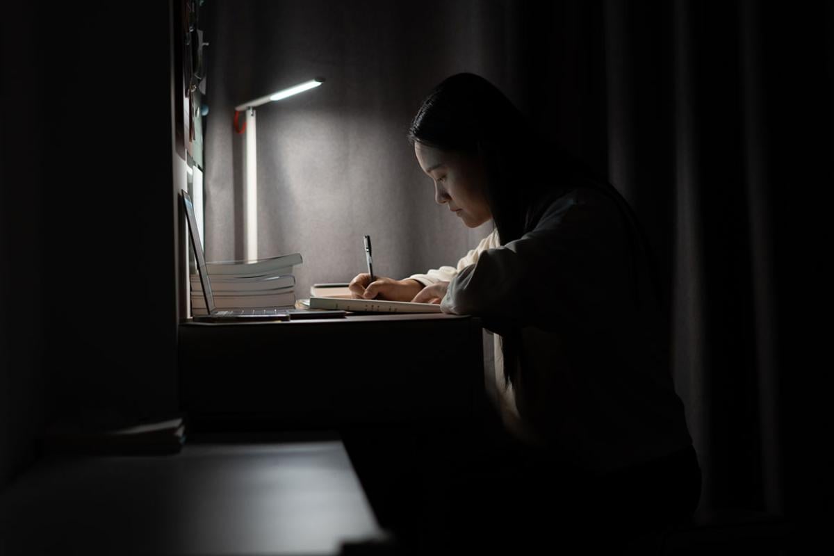 Person studying in a dimly lit room