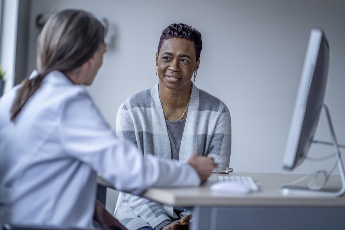 Patient speaking with a doctor in an office