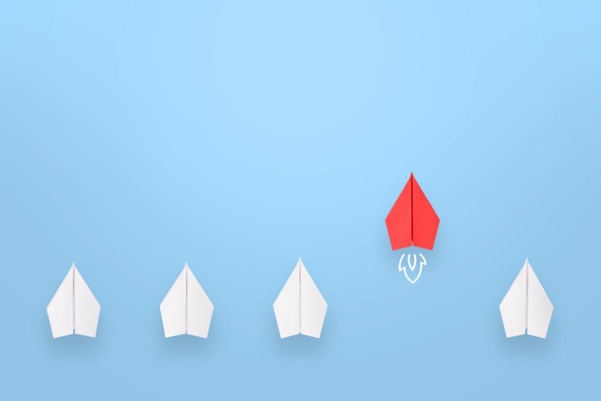 Group of paper plane in one direction and with one pointing in the different way