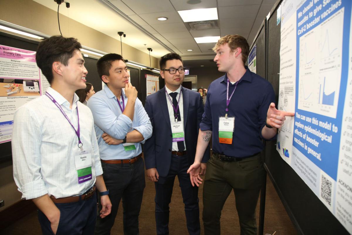 Medical student Caleb Mahlen presents a poster during the 2023 AMA Medical Student Poster Showcase