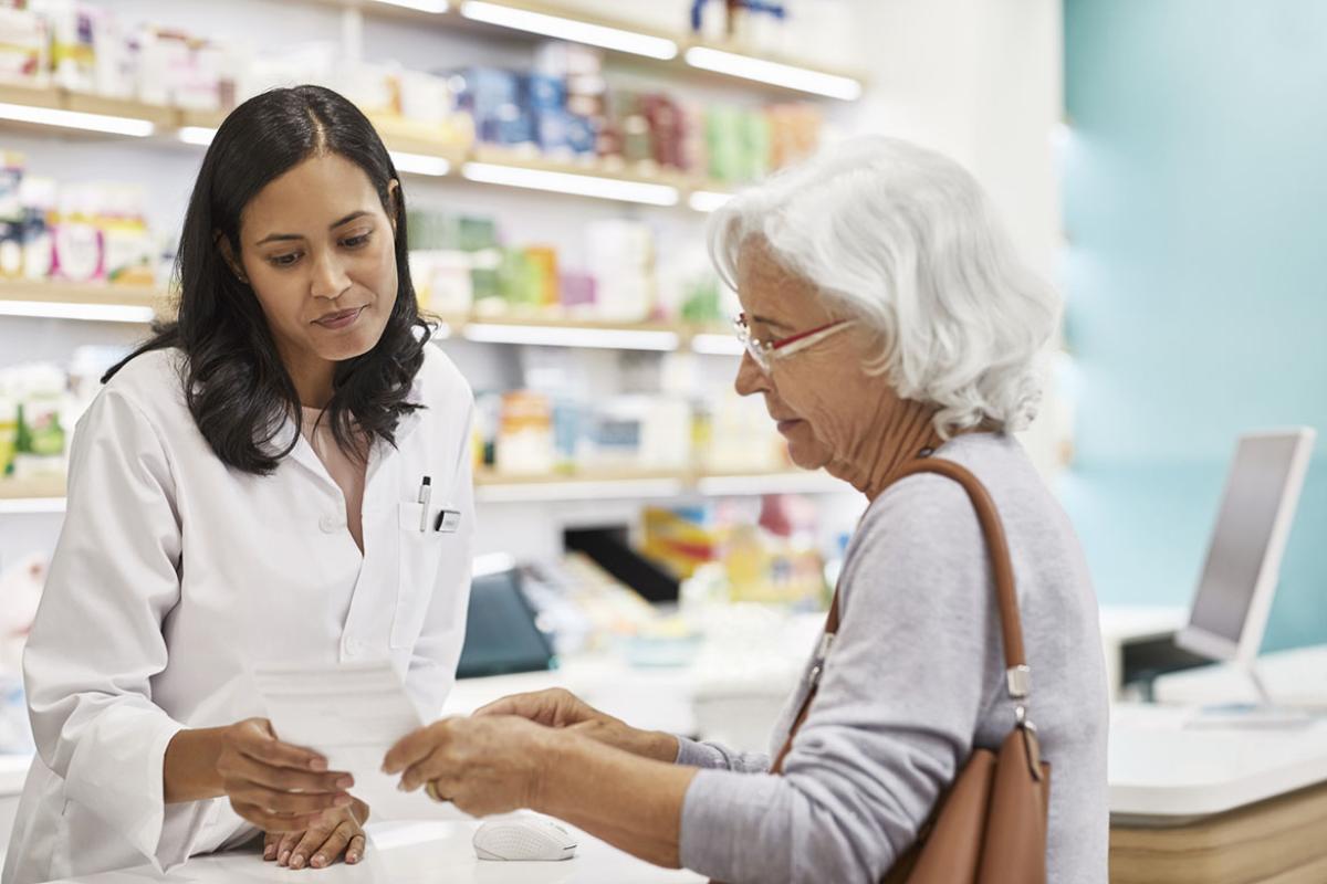 Customer showing prescription to health care worker
