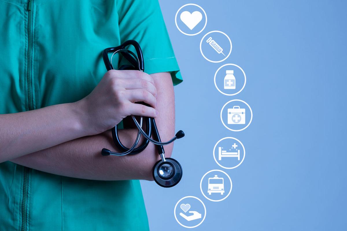 Health care worker holding stethoscope accompanied by health-related icons