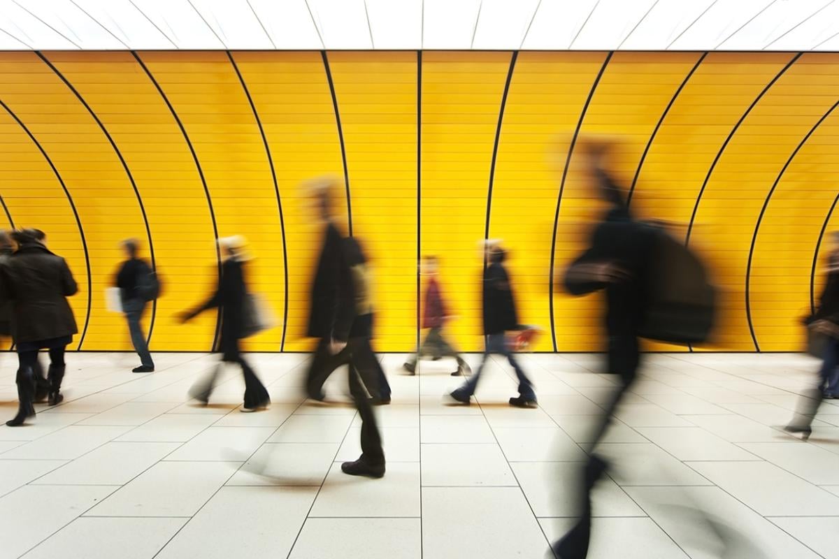 Blurred image of commuters in a tunnel