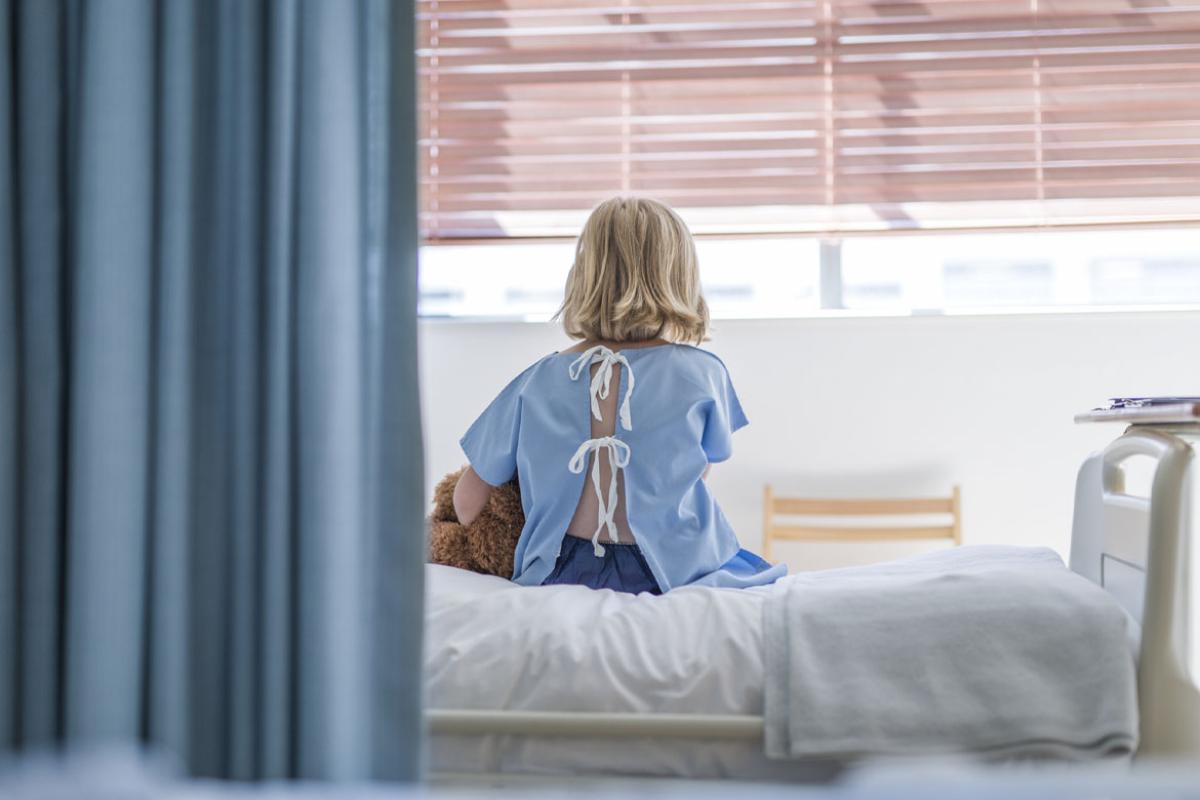 Young patient sitting on hospital bed