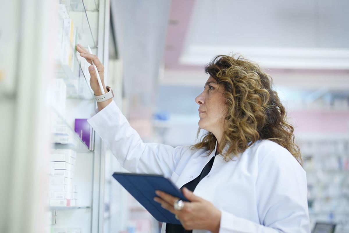 Pharmacist holding a digital tablet in a pharmacy 