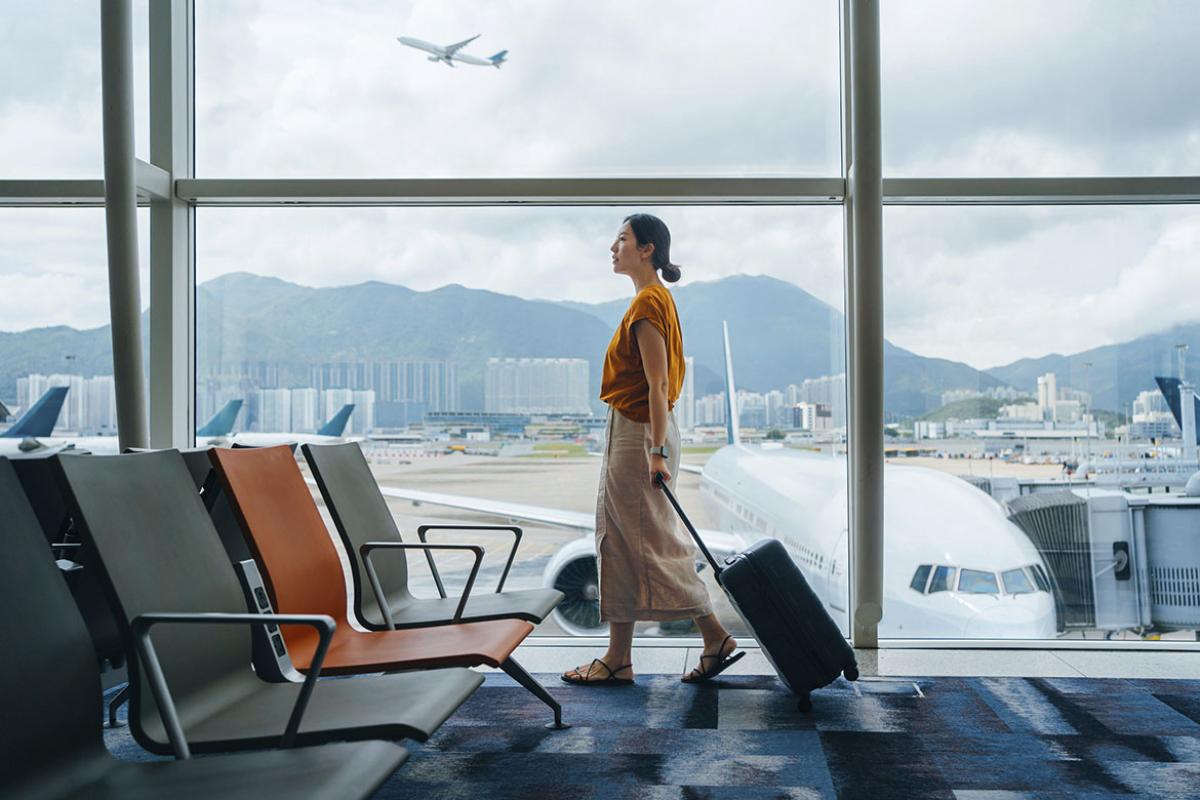 Traveler wheeling luggage through an airport