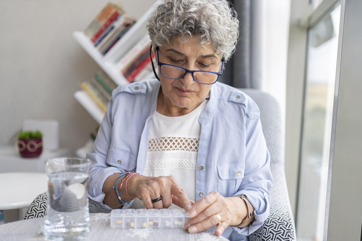 Elderly patient organizes weekly prescriptions