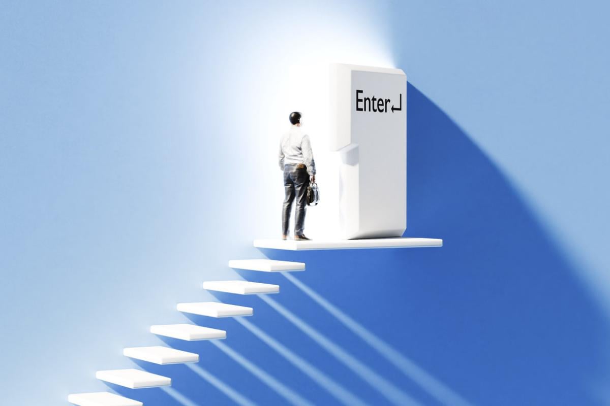 Figure at the top of stairs in front of a door shaped like an Enter key