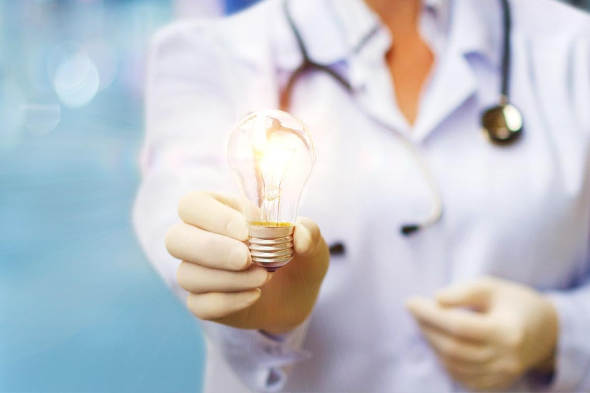 Physician holding a light bulb