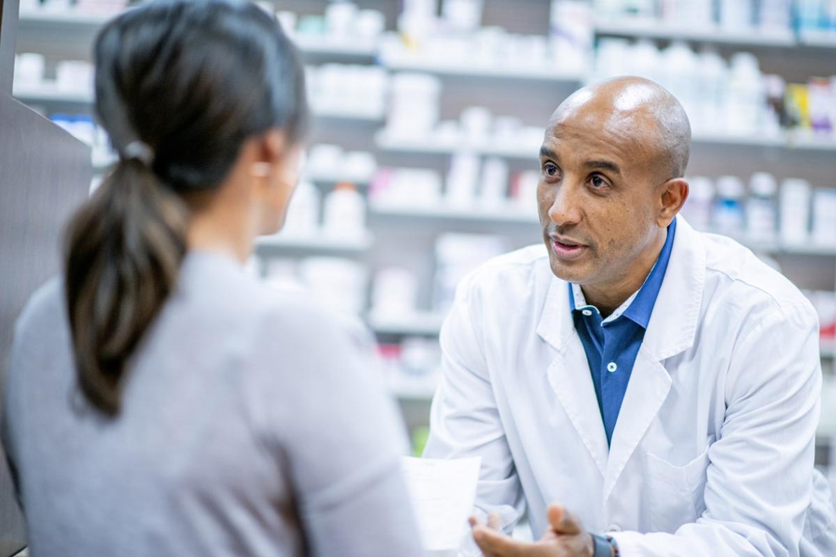 Pharmacist speaks with customer
