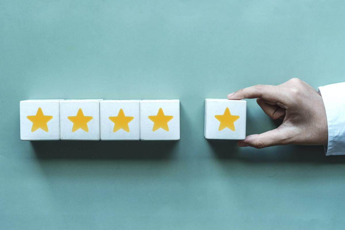 Hand places a block with a star in a row