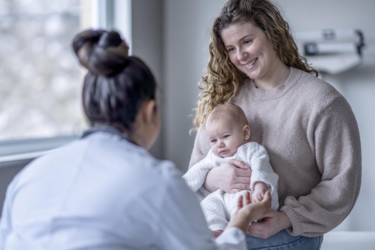 Baby holding a doctor's finger