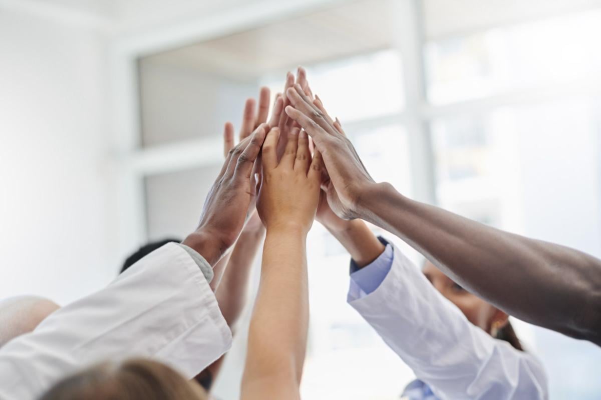 Group of health care workers high five