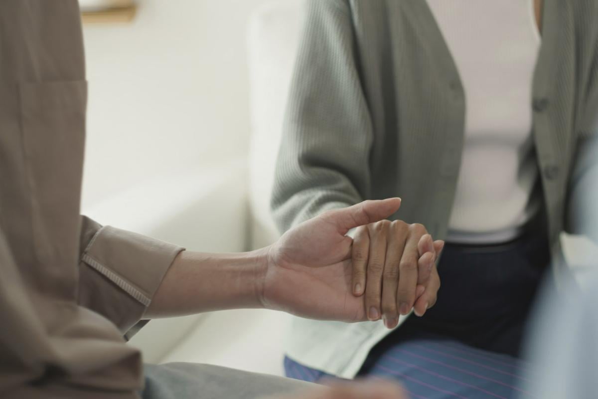 Supportive group holding hands