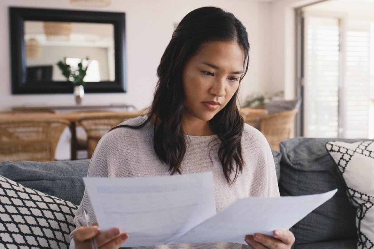 Person holds two pieces of paper
