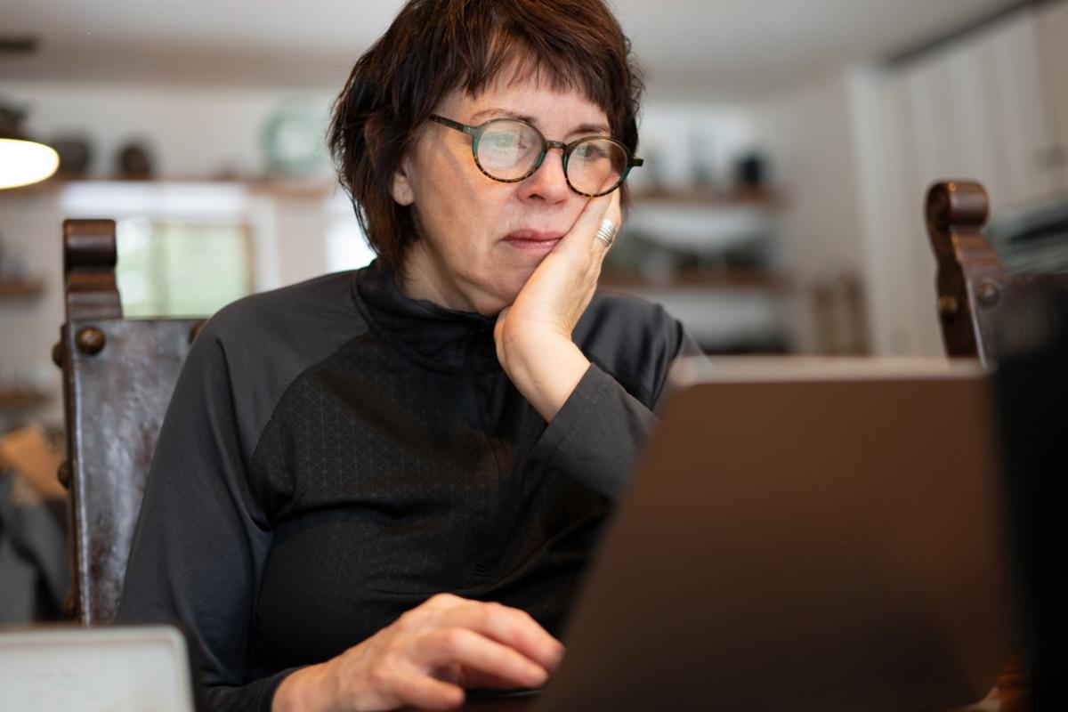 Person sits in front of laptop