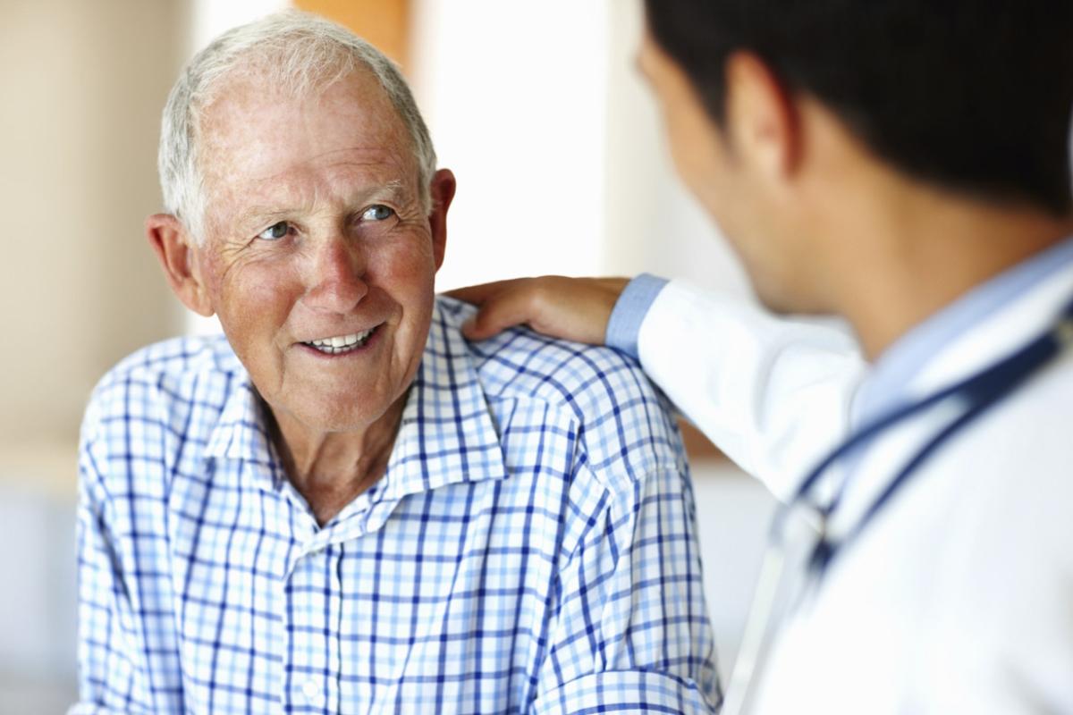 Doctor with a hand on a smiling patient's shoulder
