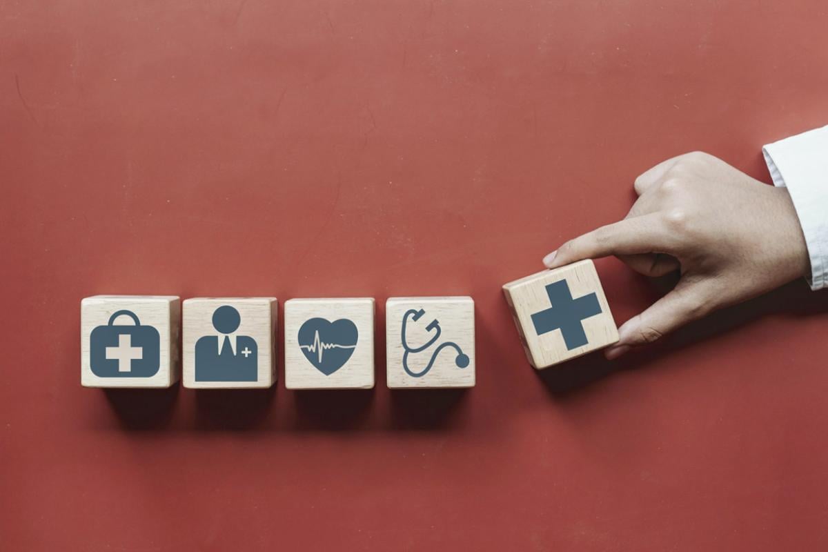 Hand placing blocks in a row