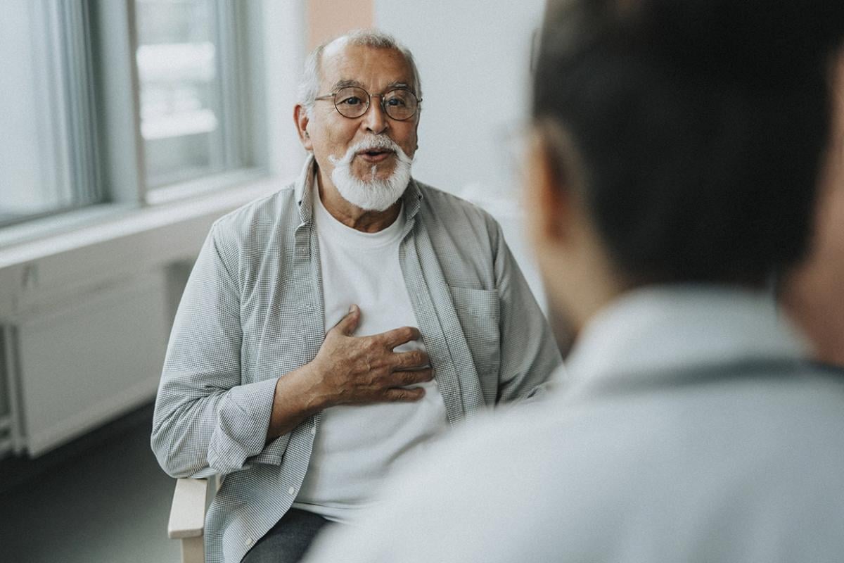 Elderly patient gestures to chest