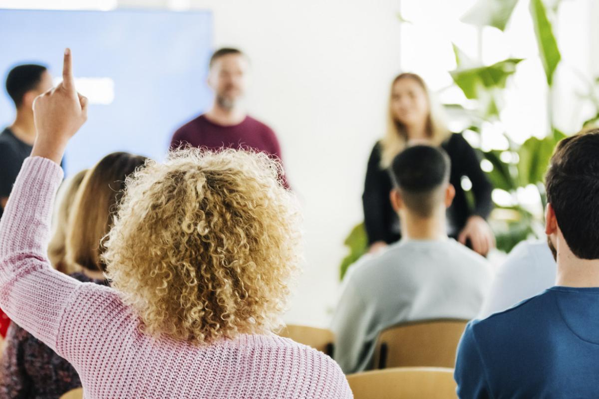 Audience member with hand raised