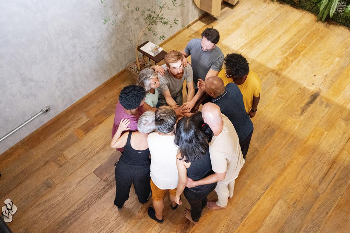 People in a group with stacked hands