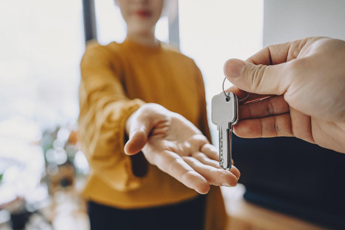 Outstretched hand waits for keys from another hand