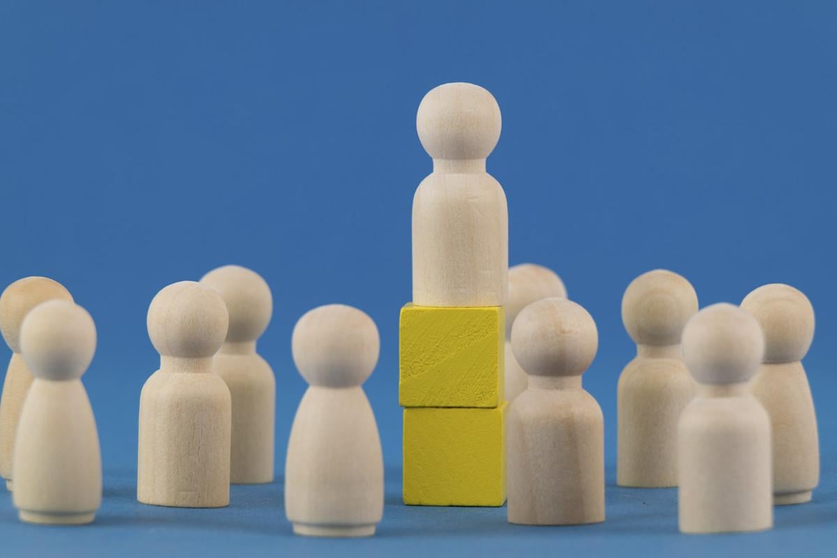 Wooden block elevated among other wooden blocks