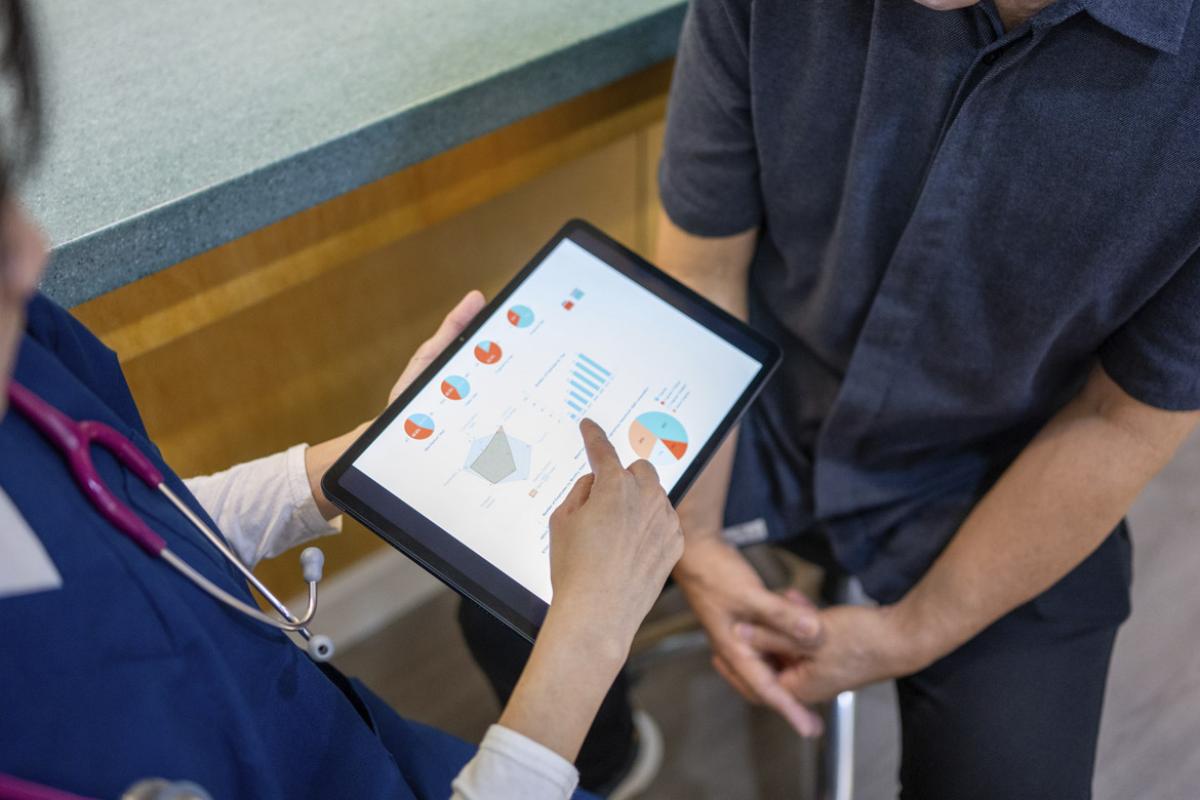 Physician points at tablet