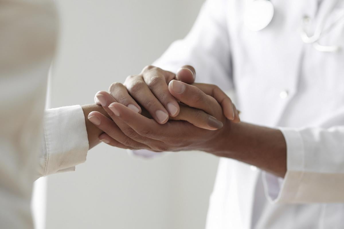 Doctor holds a comforting hand