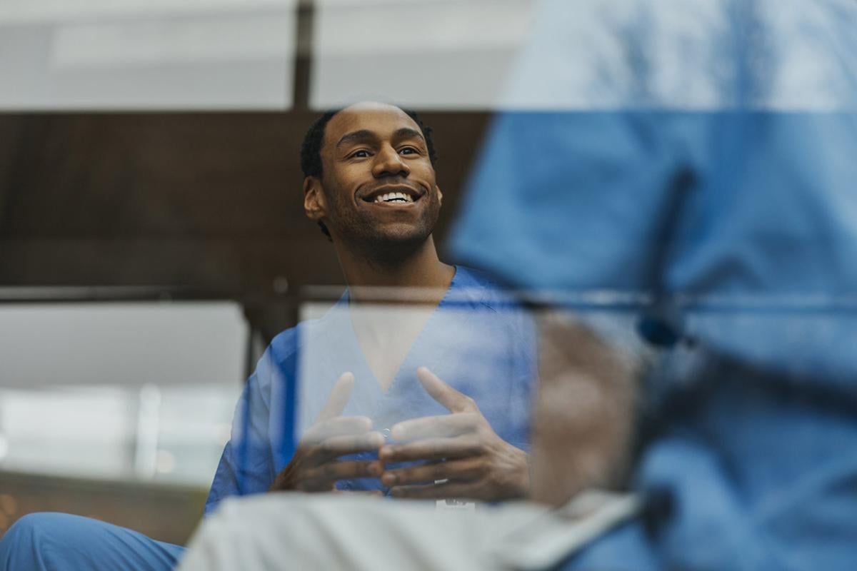 Smiling physician in conversation
