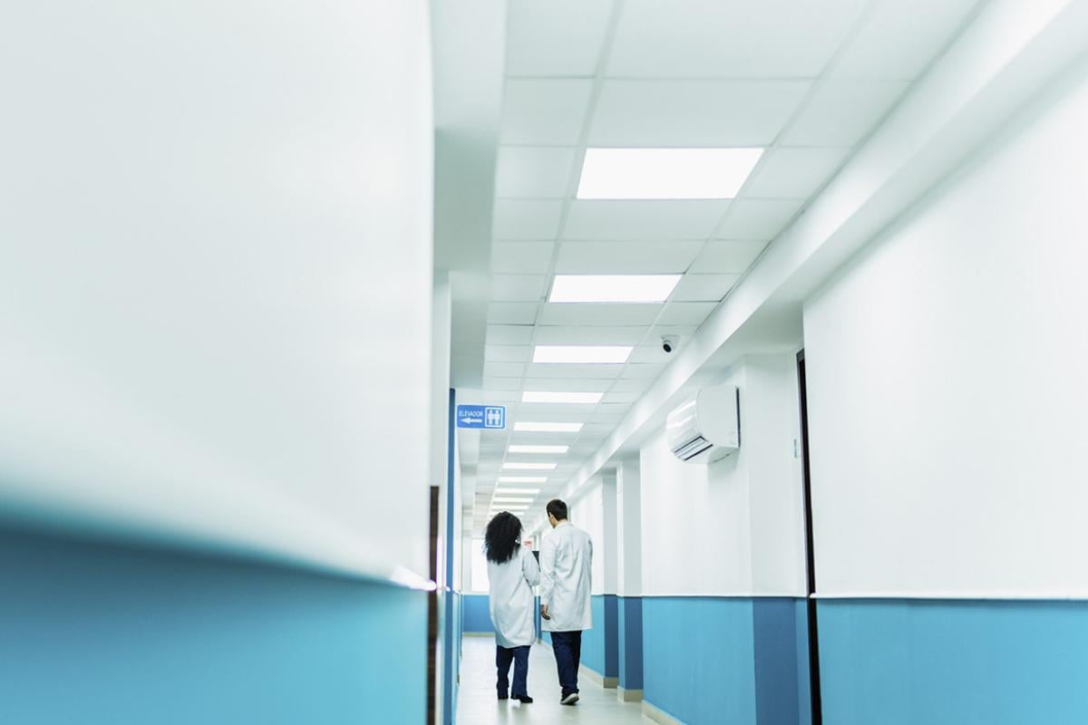 Two health care workers in a hallway