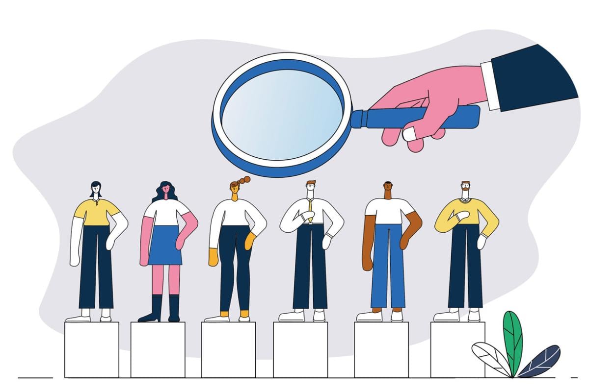 Giant magnifying glass hovers over a row of figures