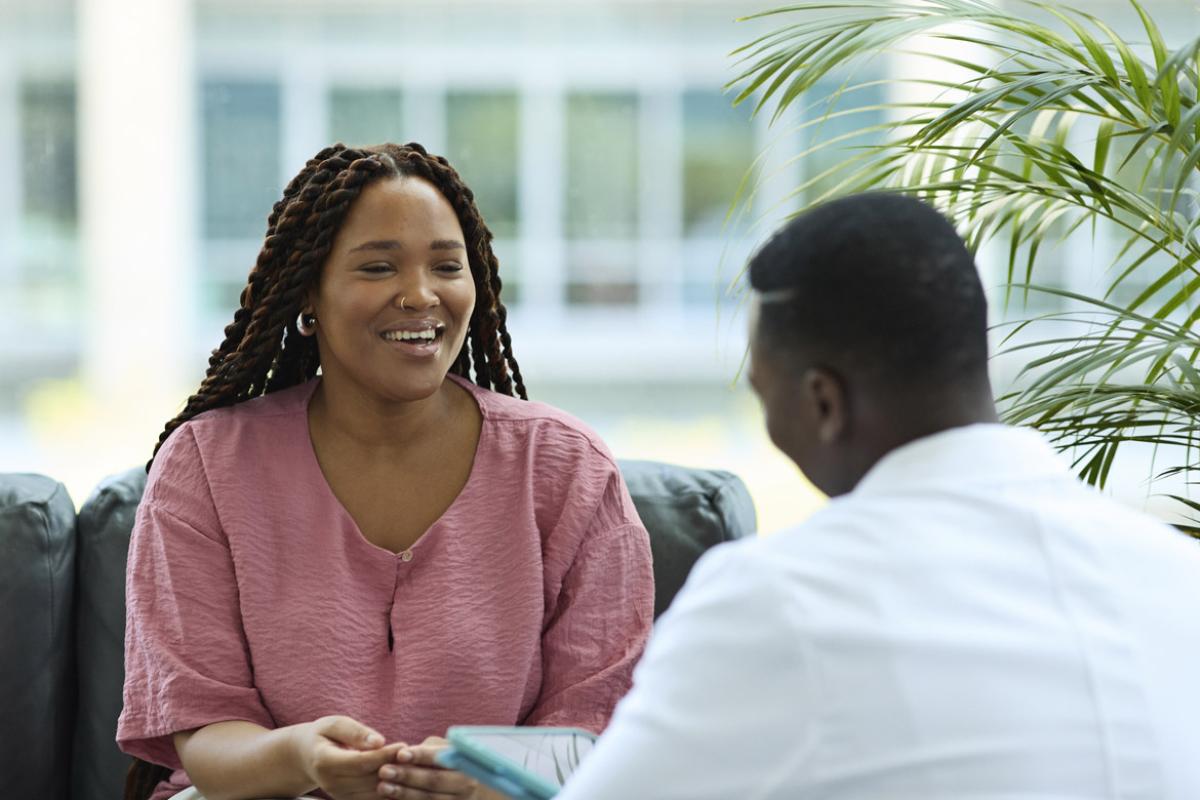 Smiling patient meets with doctor