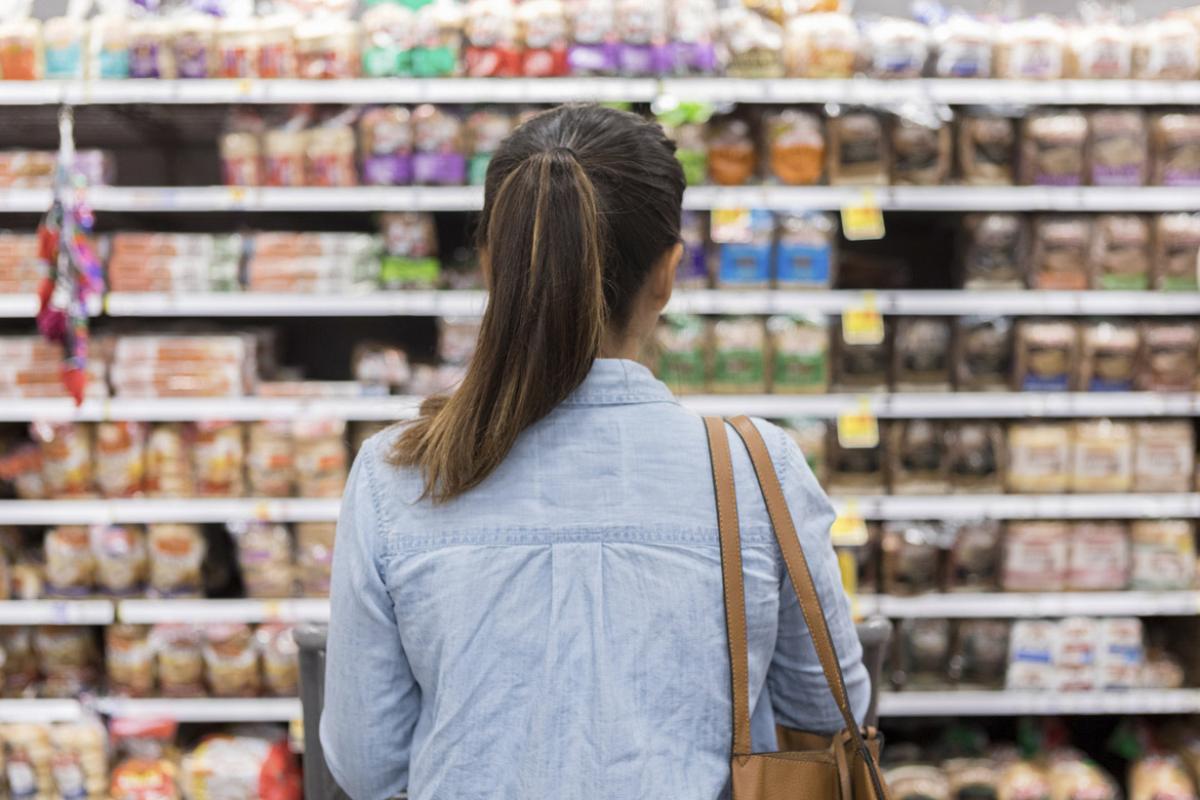 Shopper in the bread aisle of a grocery store