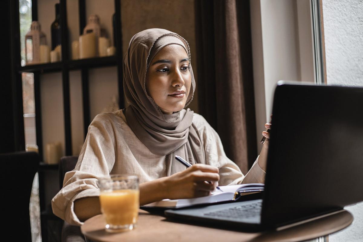 Person works in front of a laptop